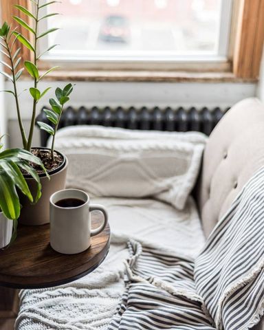 Cozy couch with coffee cup | HCRE Property Management