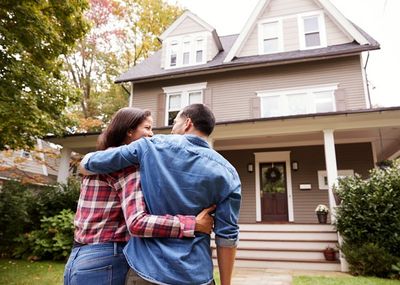 Young couple walking into their new home