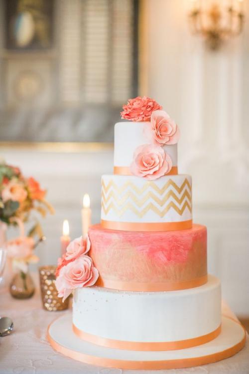 A wedding cake is sitting on a table with candles and flowers.