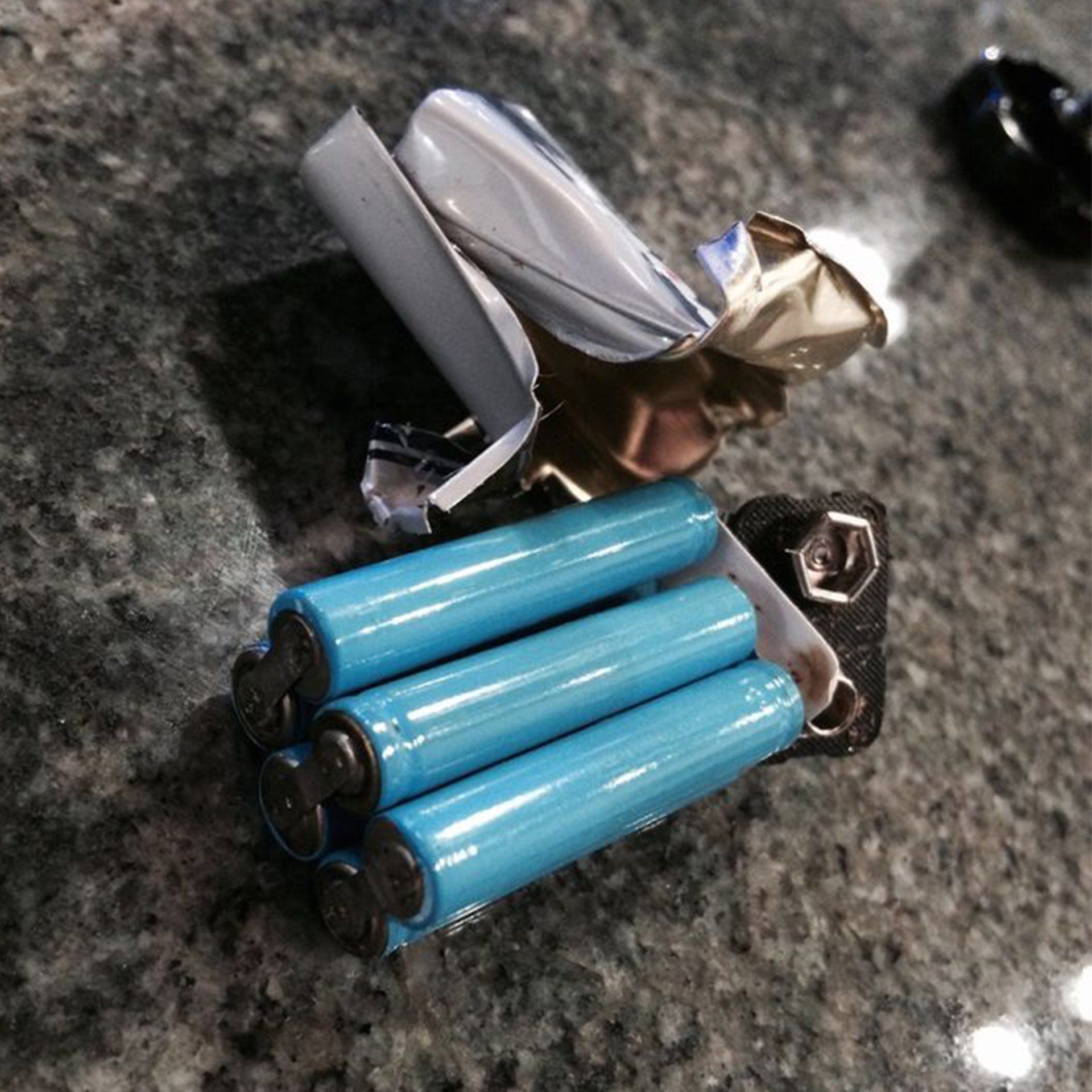 A bunch of blue batteries are sitting on a counter