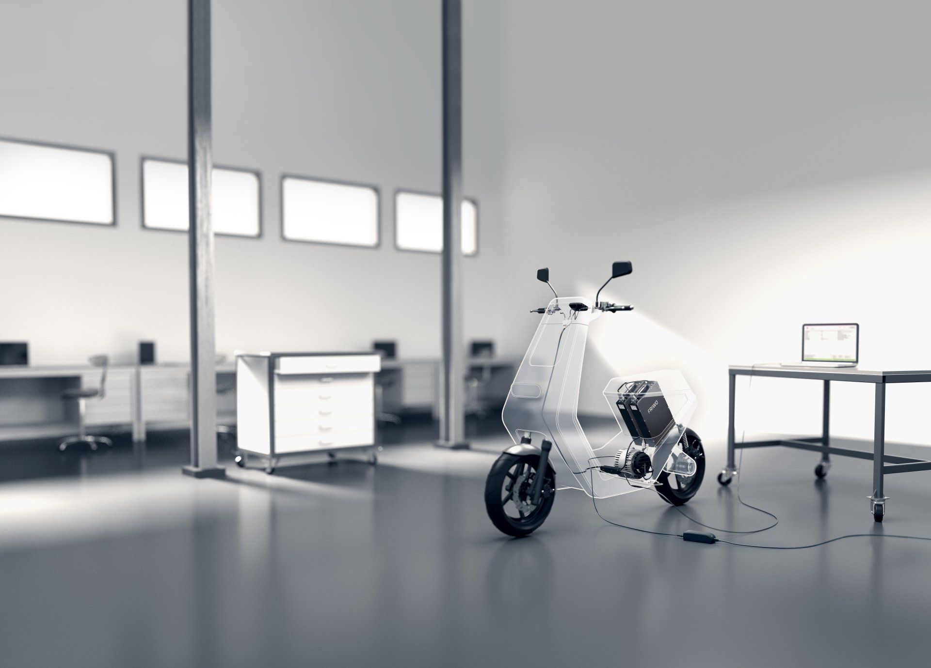 A scooter is sitting in a room with a laptop on a desk