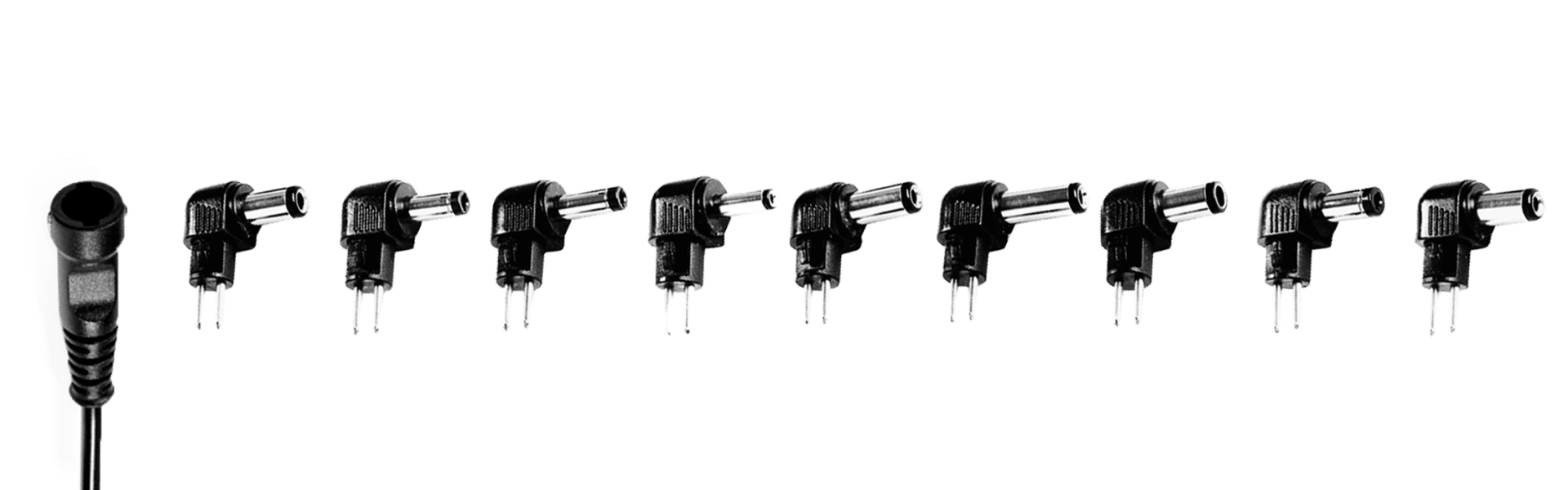 A bunch of different types of DC plugs are lined up in a row on a white background.