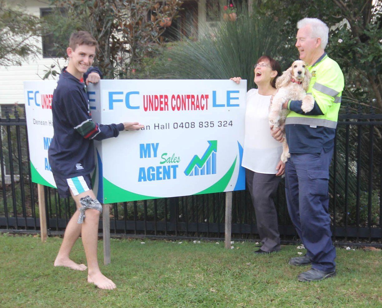 Family posing in a signage