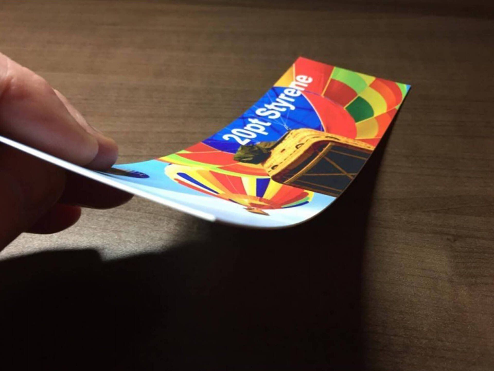 A person is holding a card that says 40ft skyride