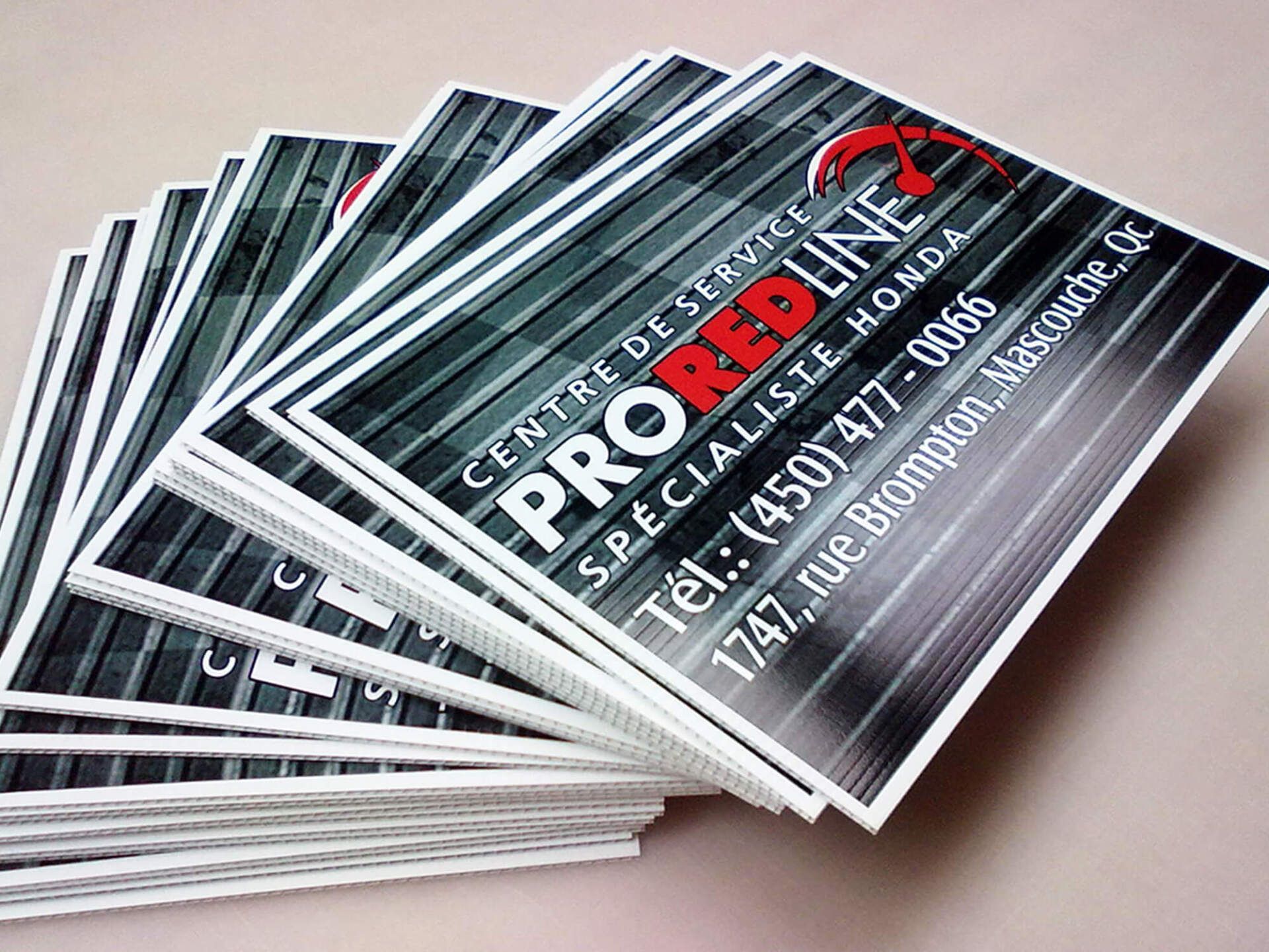 A stack of business cards for pro red line honda