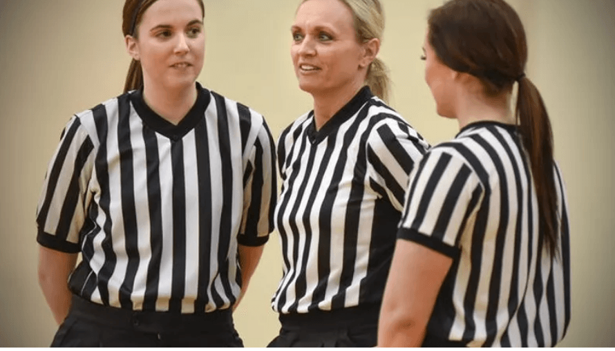 Three women in striped shirts are standing next to each other