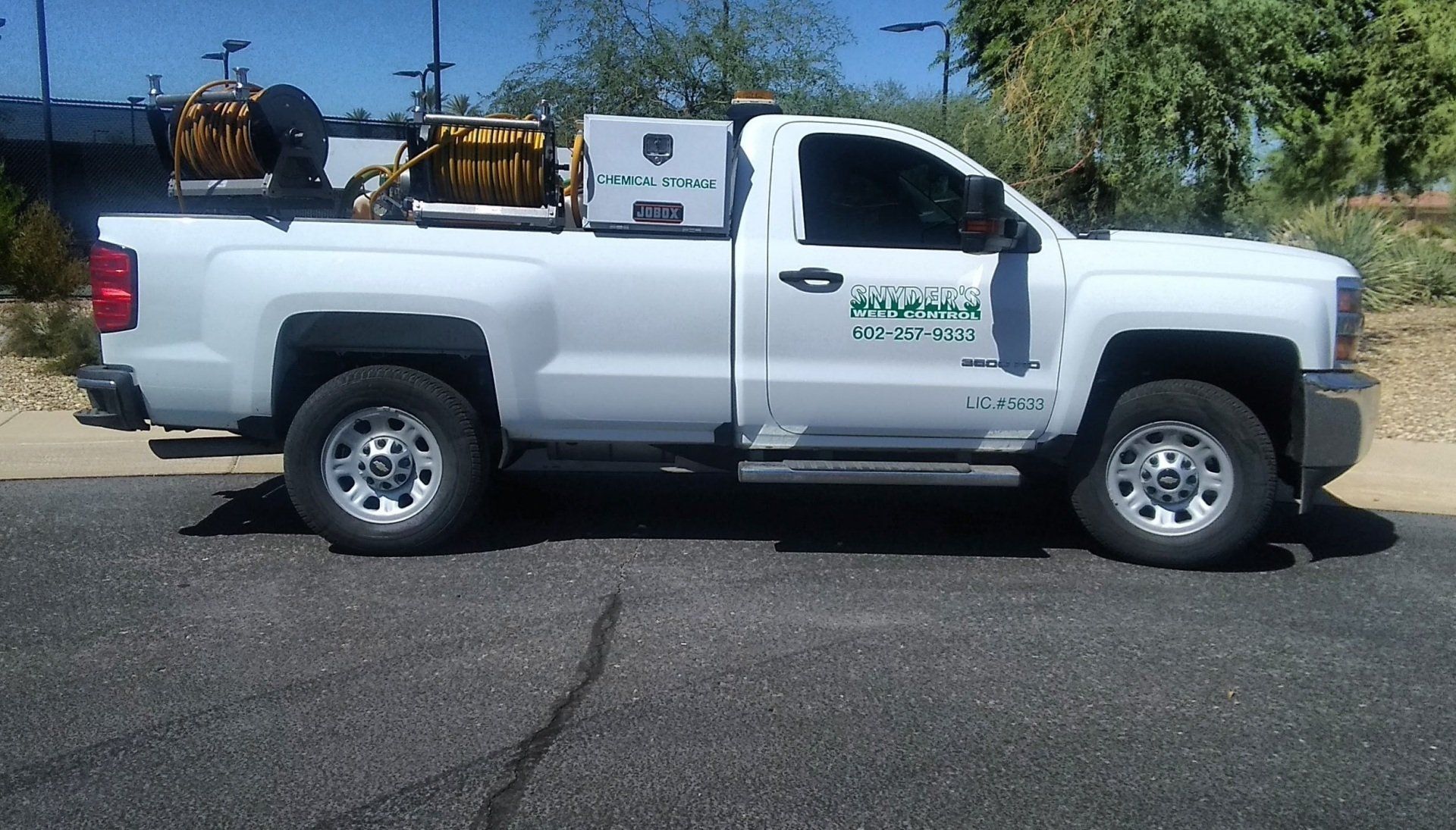 A man that is weed spraying in Mesa, AZ