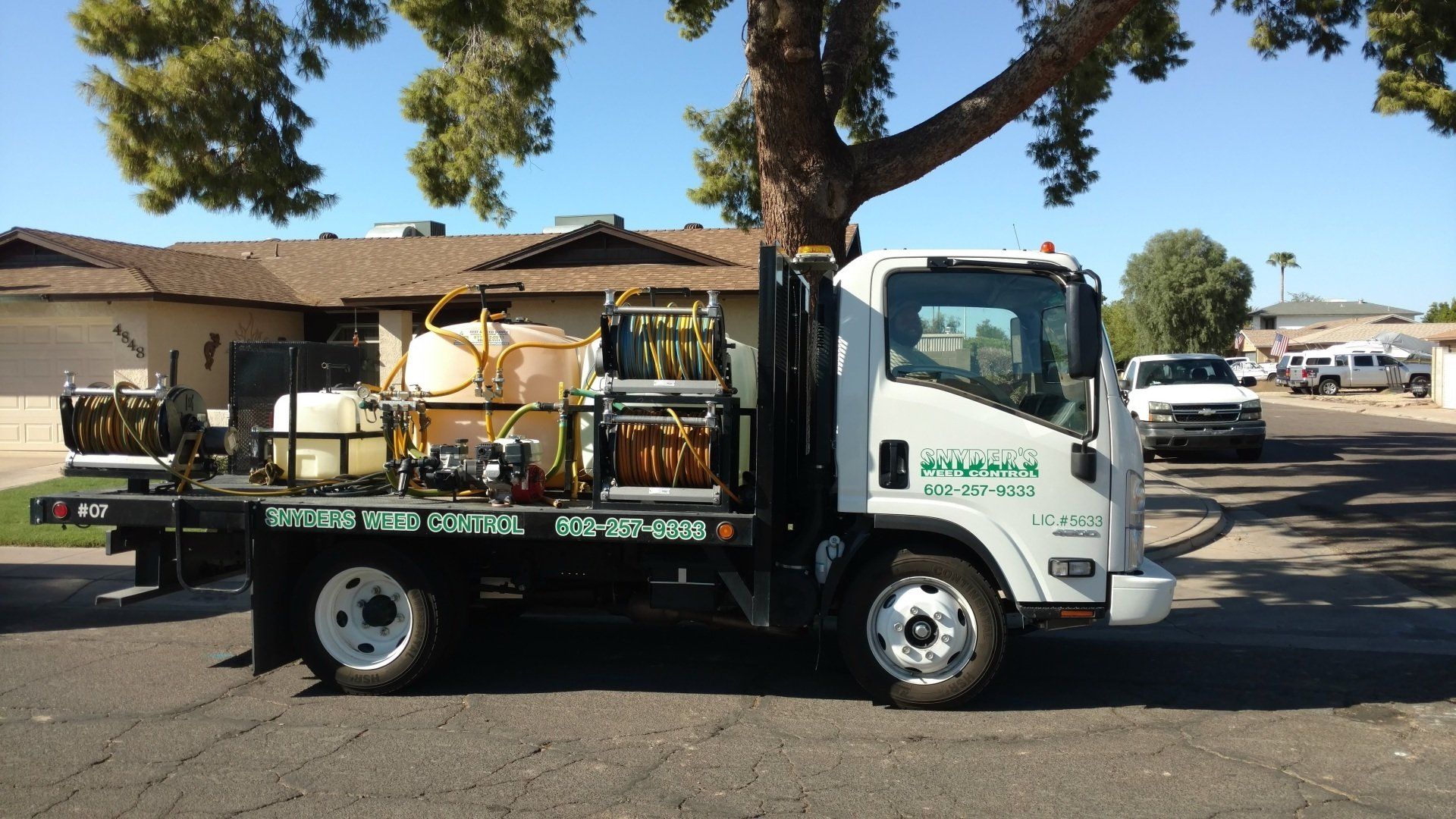 Weed-Free — Weed Prevention in Maricopa County, AZ A man that is weed spraying in Mesa, AZ