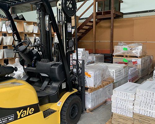 Forklift in Warehouse with Range of Tiles — Tile Supplies in Alstonville in Alstonville, NSW Forklift in Warehouse with Range of Tiles — Tile Supplies in Alstonville in Alstonville, NSW