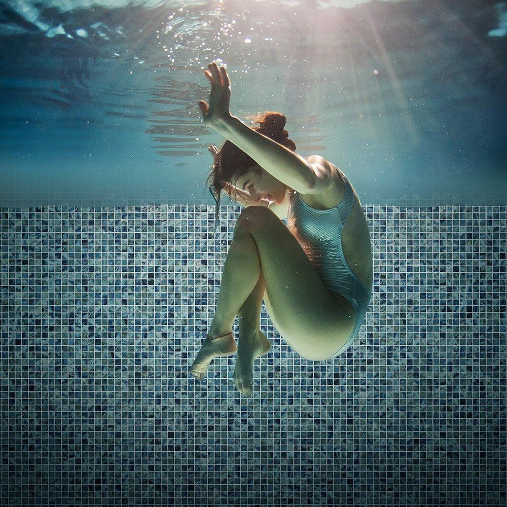 Girl in Swimming Pool with Mosaic Tiles — Tile Supplies in Alstonville in Alstonville, NSW Girl in Swimming Pool with Mosaic Tiles — Tile Supplies in Alstonville in Alstonville, NSW