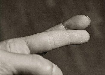 Individual with finger crossed