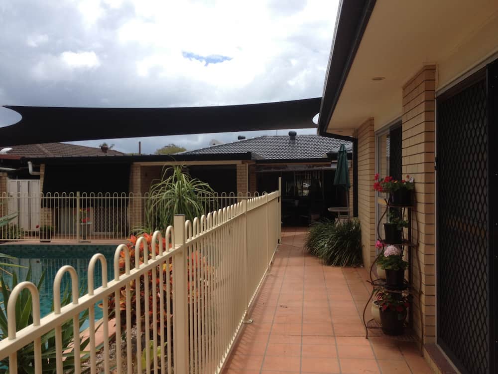 A House With a Fence and a Pool in the Backyard — Killiby & Co Roofing Pty Ltd in Tweed, NSW