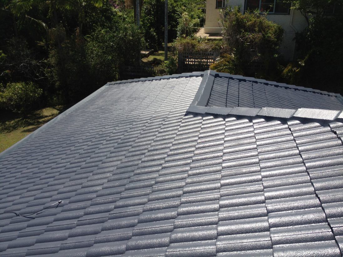 A Roof With a Lot of Tiles on It and Trees in the Background — Killiby & Co Roofing Pty Ltd in Tweed, NSW
