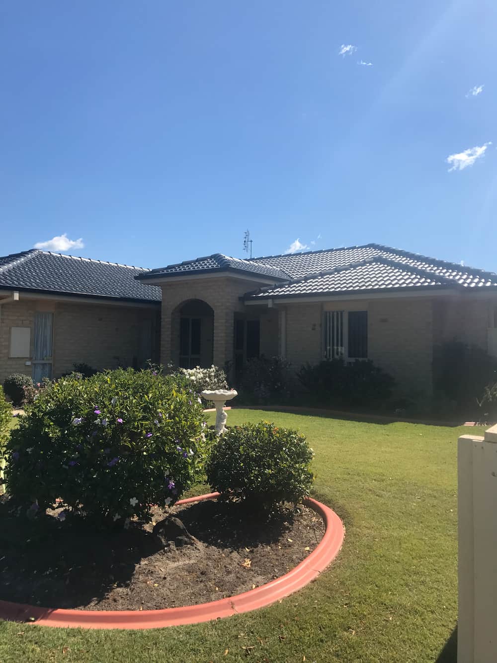 A Large House With a Lush Green Lawn in Front of It — Killiby & Co Roofing Pty Ltd in Tweed, NSW