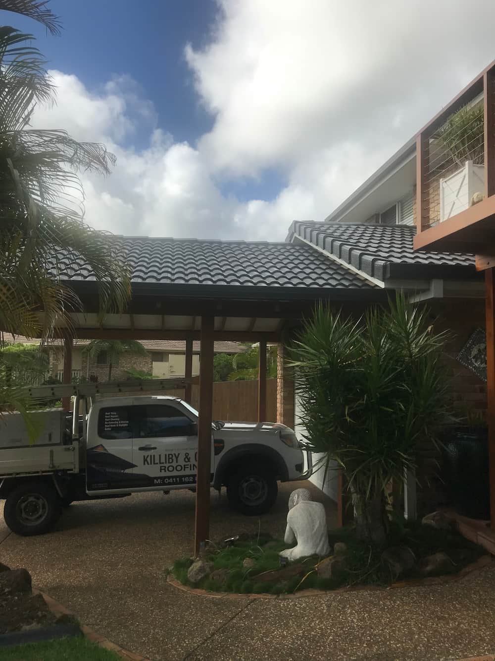 A Truck is Parked Under a Canopy in Front of a House — Killiby & Co Roofing Pty Ltd in Tweed, NSW