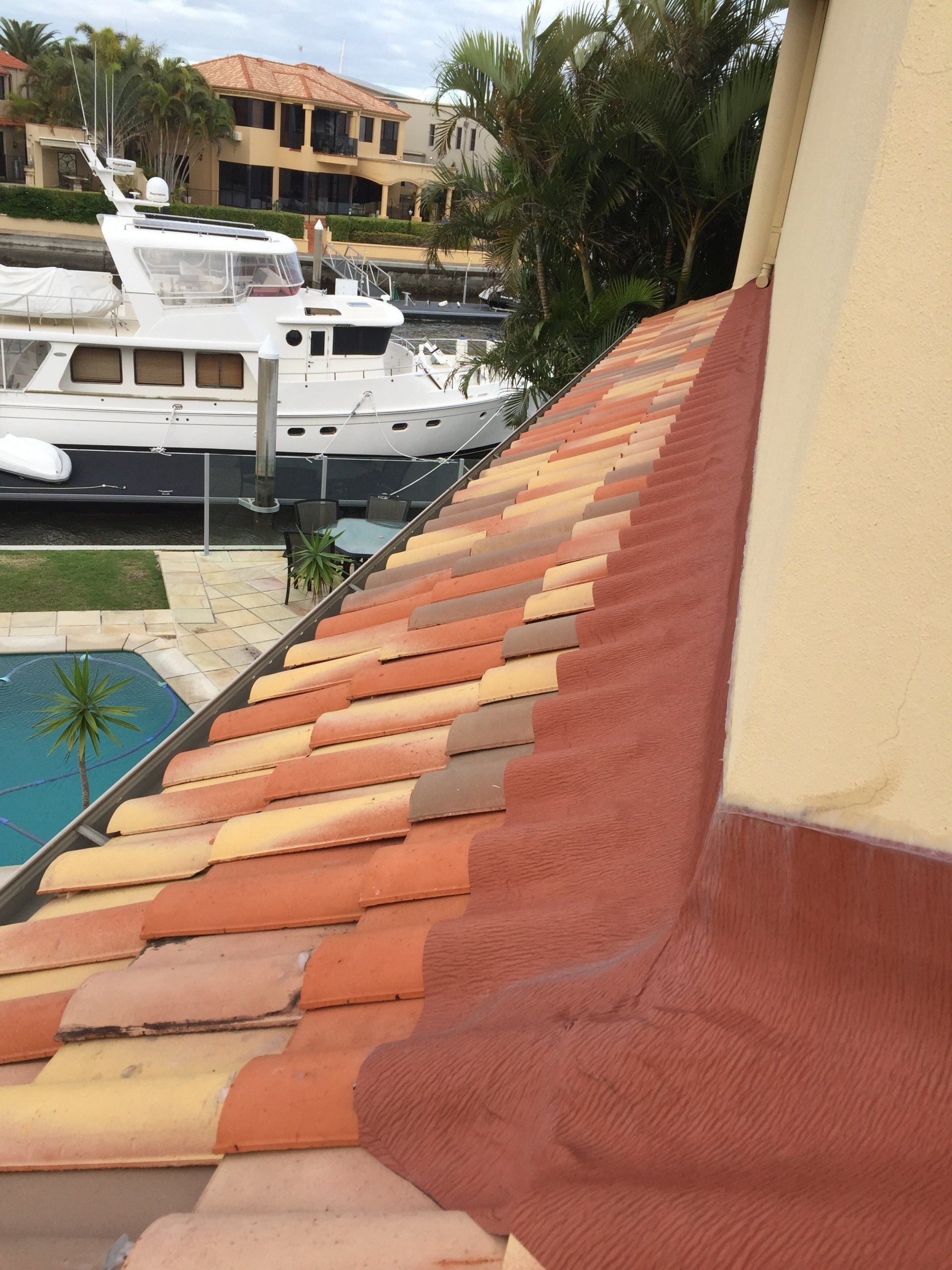 A Roof With a Boat in the Background and a Foreground  Pool — Killiby & Co Roofing Pty Ltd in Tweed, NSW