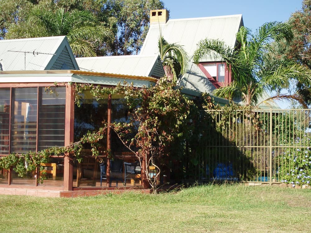 A House With a Porch and a Fence in Front of It — Killiby & Co Roofing Pty Ltd in Tweed, NSW