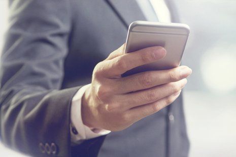Secure Call Center — Man Holding Mobile Phone in Las Vegas, NV Secure Call Center — Man Holding Mobile Phone in Las Vegas, NV