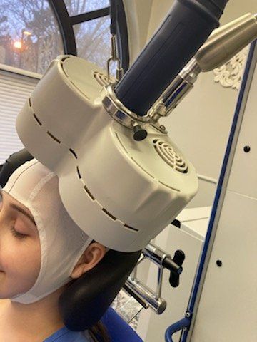 A person under a medical device that is placed over the head.