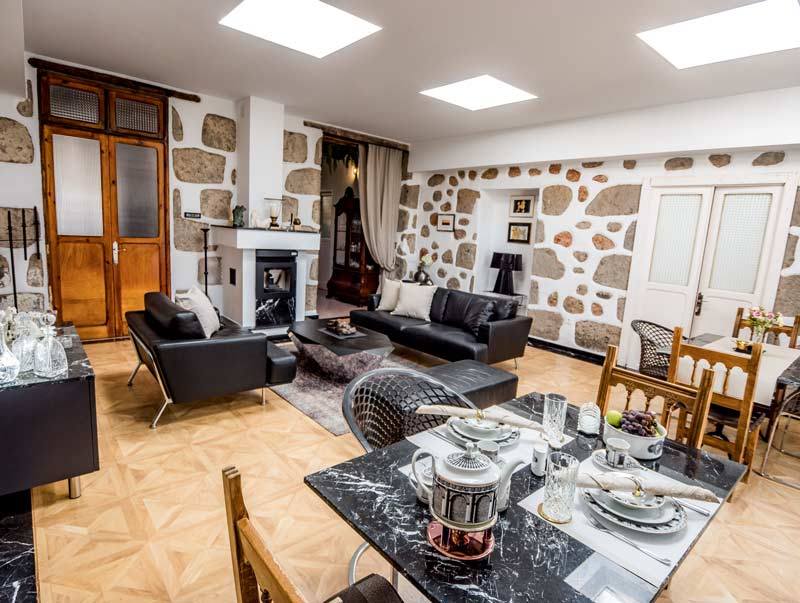 Ein Wohnzimmer mit Esstisch und Stühlen und einem Kamin.