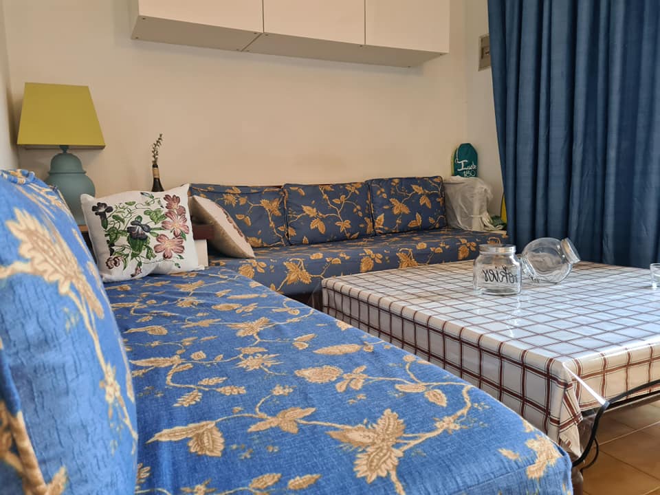 Ein Wohnzimmer mit einer blauen Couch und einem Tisch