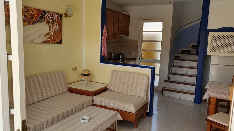 Ein Wohnzimmer mit Sofa und Stühlen und Treppen