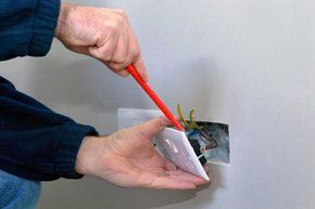 For an electrician in Blackpool call Andrew James Electrical Services electrician fixing a plug socket