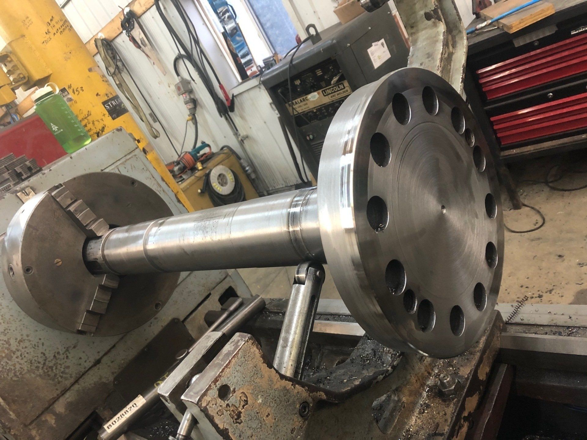 A large piece of metal is being worked on by a machine.