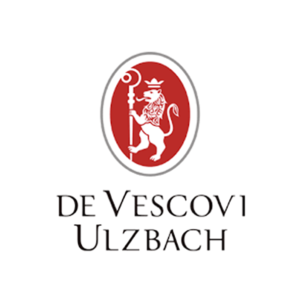 Ein rot-weißes Logo für De Vescovi Ulzbach