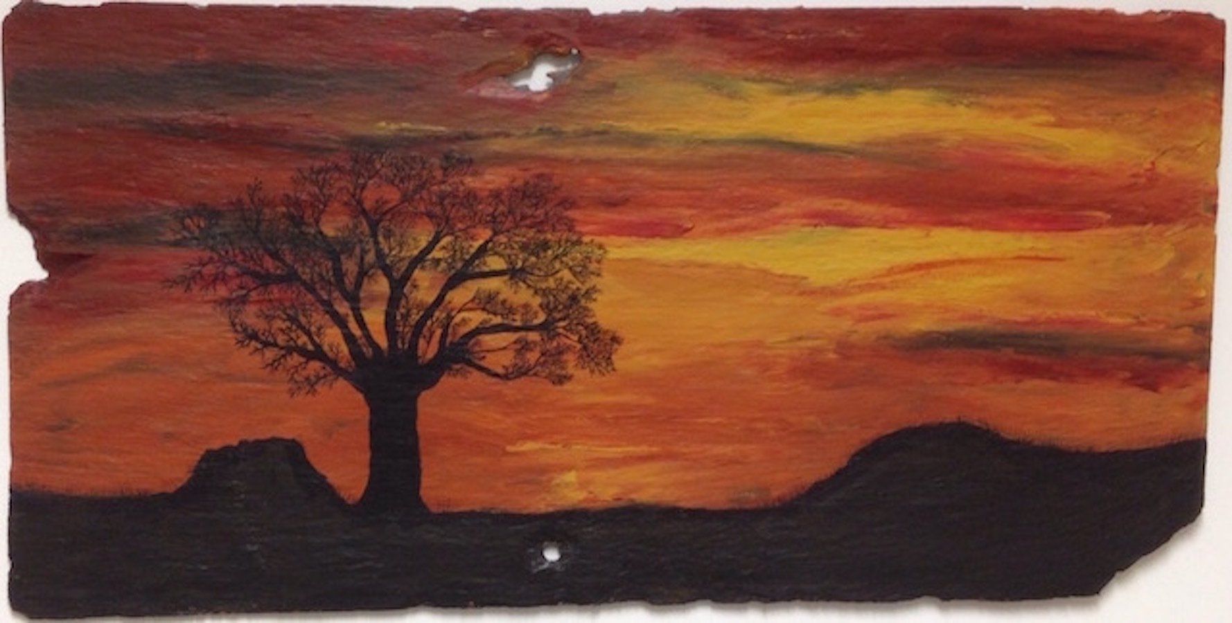 Kitty S Dale. Winter Sunset. Acrylic painting of sunset and bare tree on slate