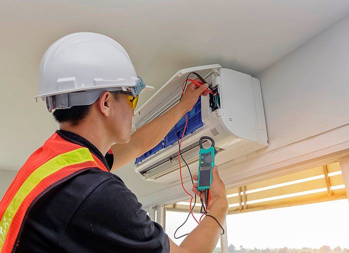 A man doing AC maintenance in Fresno, CA