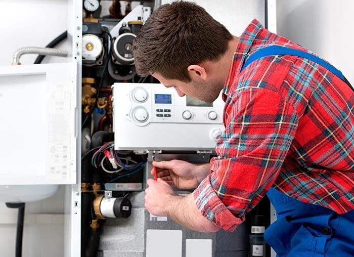 Technician Finishing a Furnace Repair in Fresno, CA Technician Finishing a Furnace Repair in Fresno, CA
