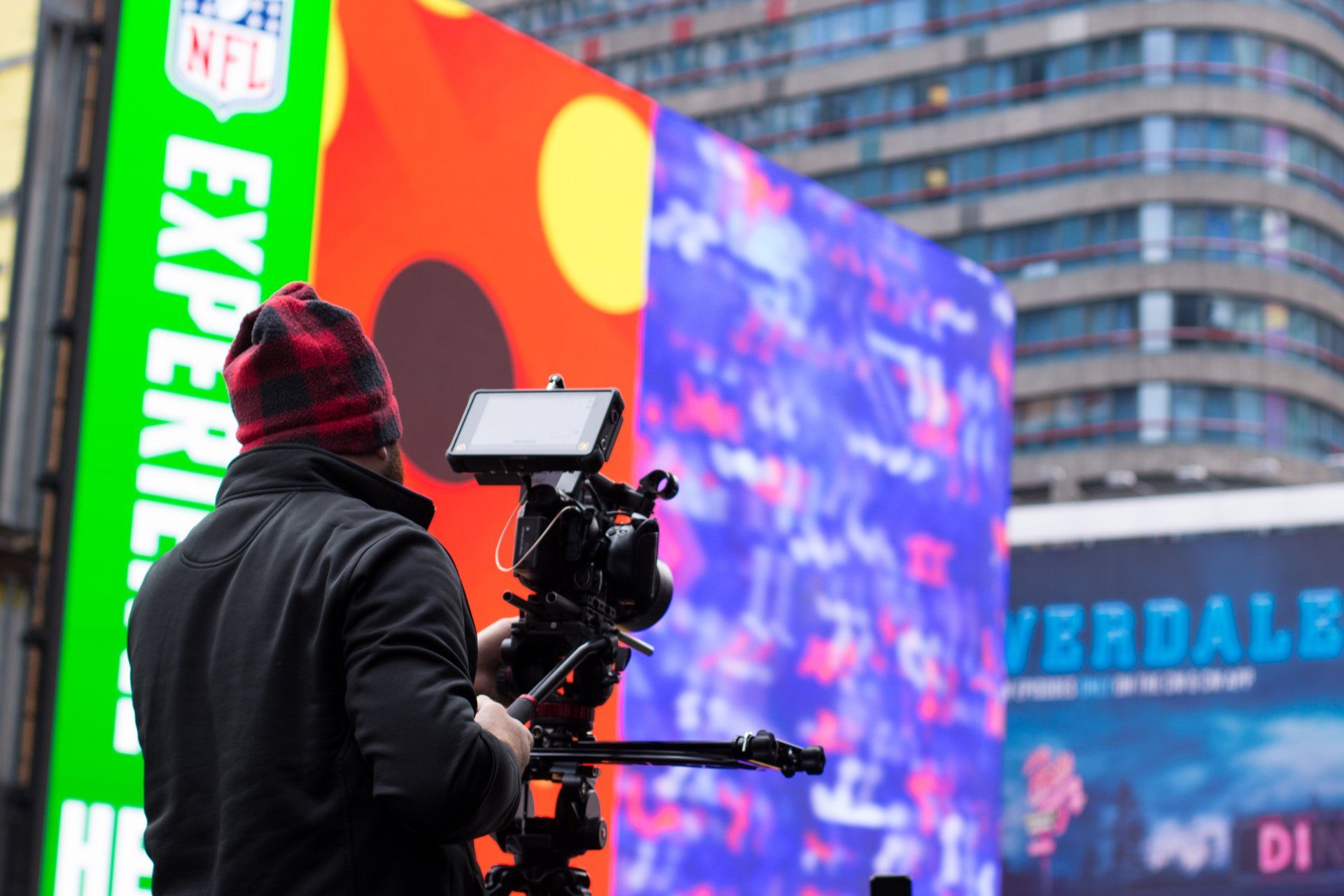 Camera operator filming branded content in New York City's Times Square during an on-location video production.