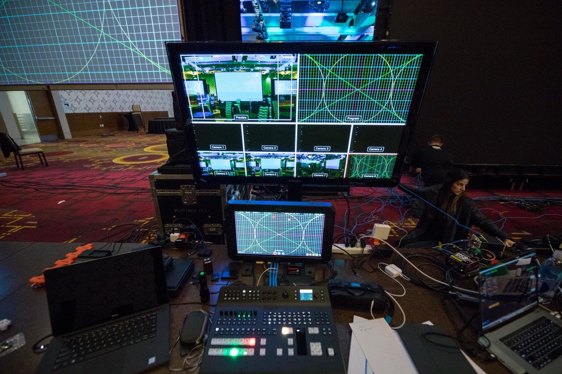 Video engineering workstation managing camera feeds, graphics, and live production systems during a corporate event.