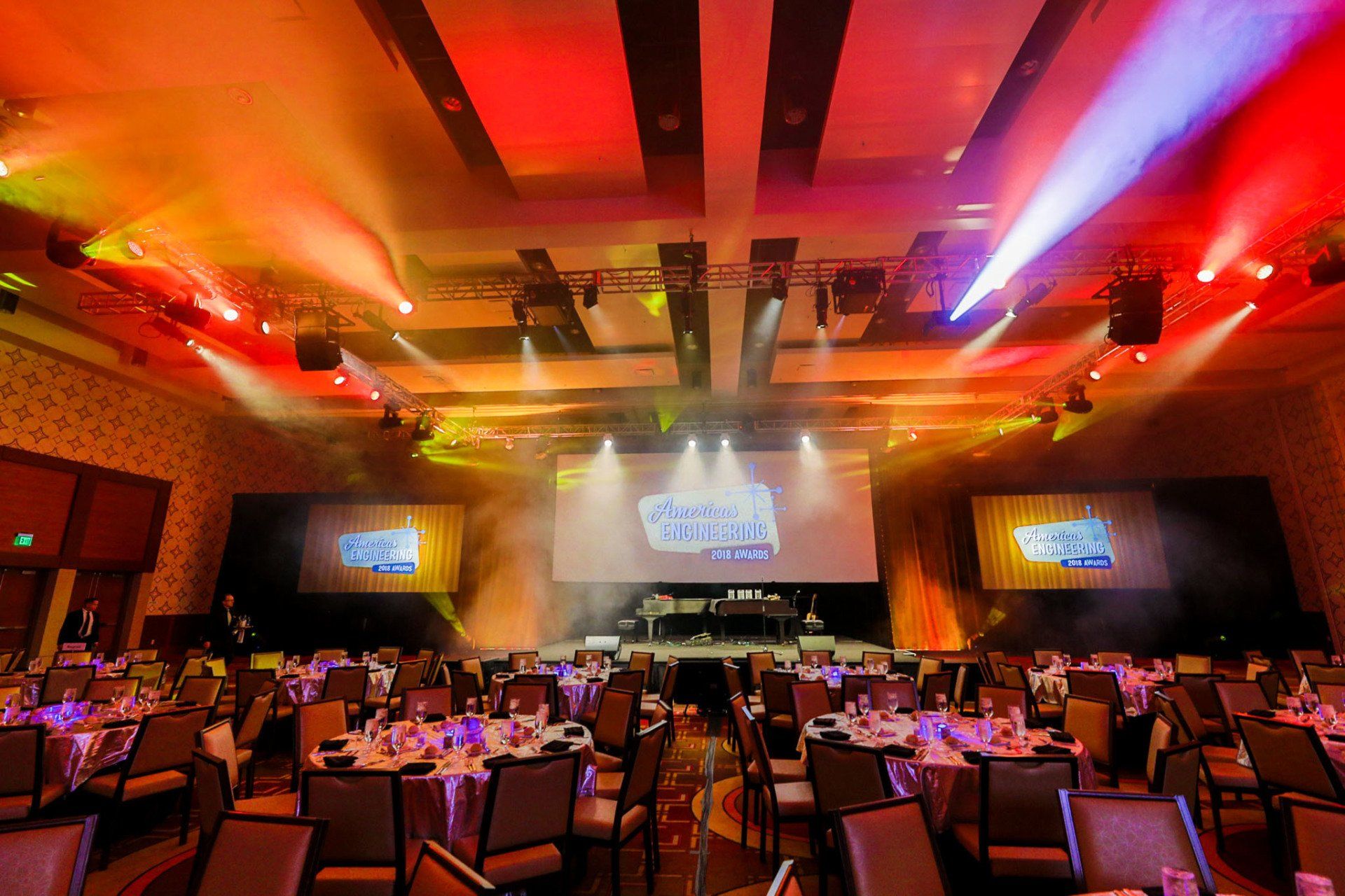 Custom event lighting and scenic production transforming a ballroom for a corporate awards banquet.