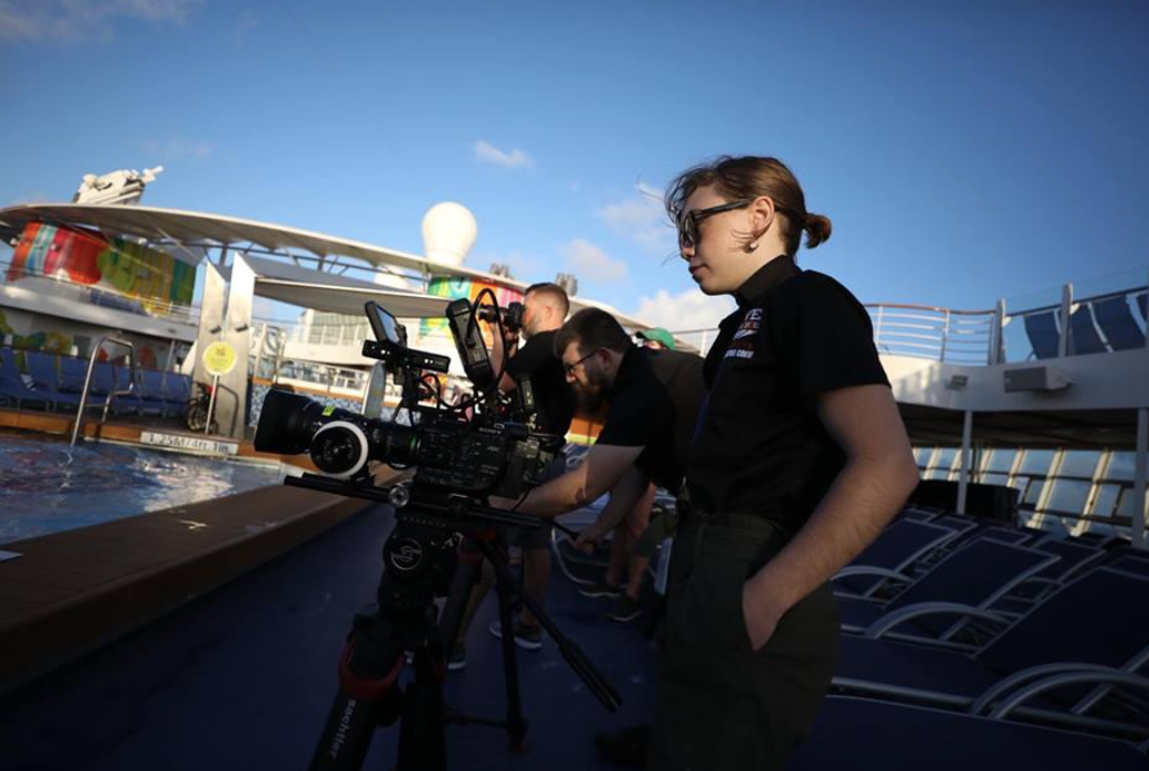 Video production crew filming branded content on location aboard a Royal Caribbean cruise ship.