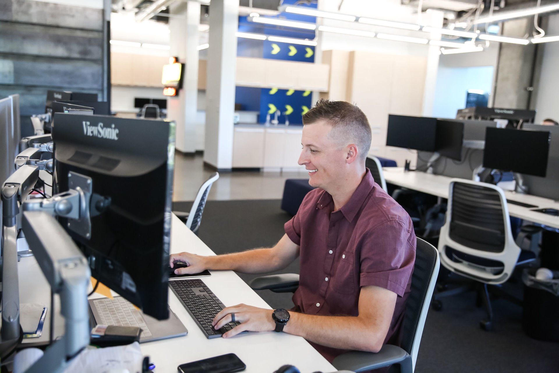 A man is sitting at a desk in front of a computer.