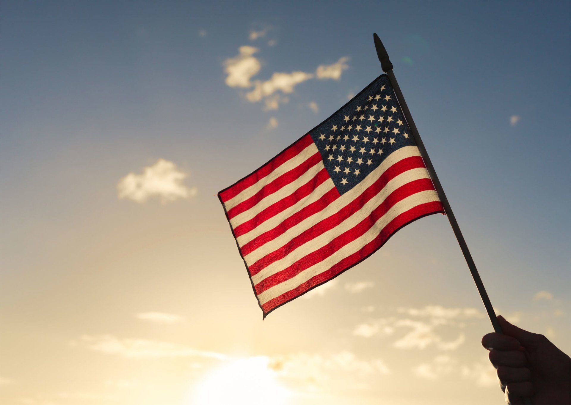 Person Holding American Flag — Peekskill, NY — Segreto Law Offices, PC
