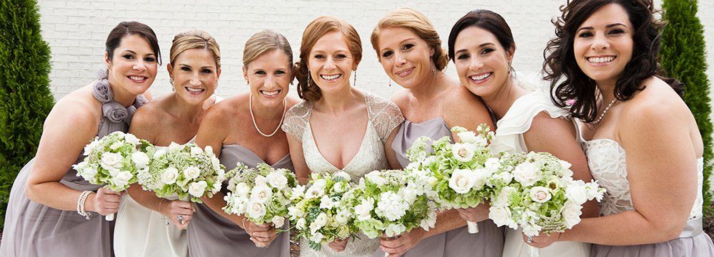 bride and bridesmaids smiling together