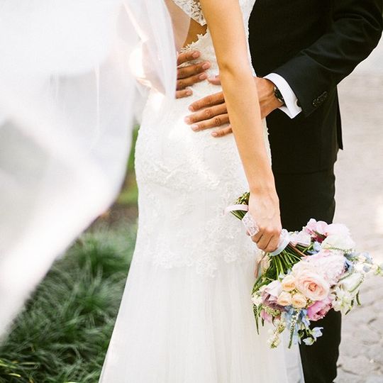 groom embracing his bride