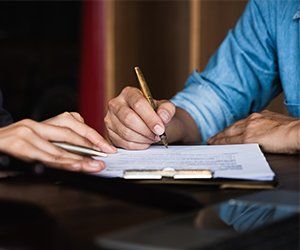 Personal Injury — Man Signing on Paper in Lake City, FL Personal Injury — Man Signing on Paper in Lake City, FL