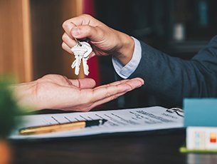 Real Estate — Man Handing Keys to Client in Lake City, FL Real Estate — Man Handing Keys to Client in Lake City, FL