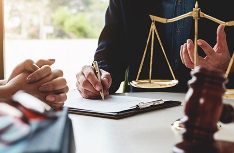 Business Law — Lawyer Writing on Paper in Lake City, FL Business Law — Lawyer Writing on Paper in Lake City, FL