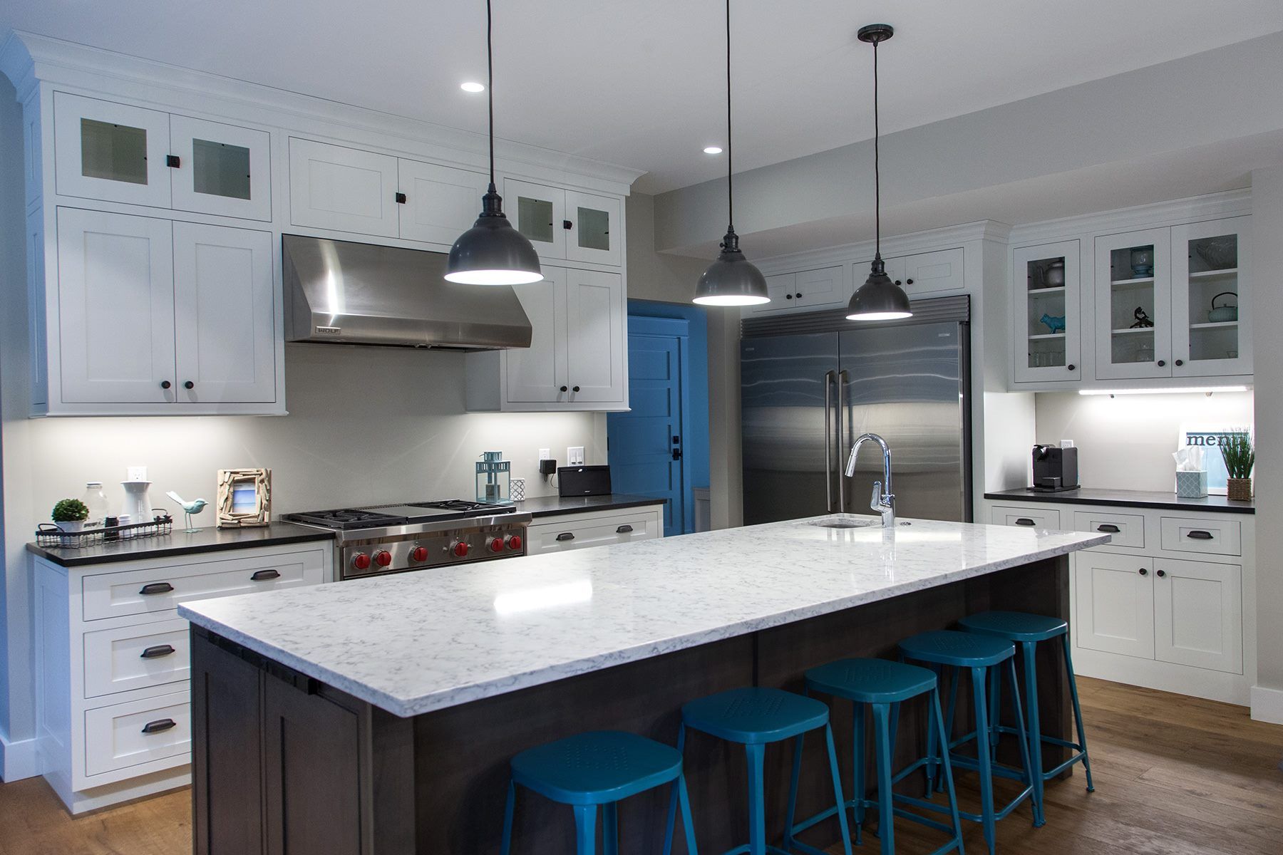 Kitchen Showroom with Blue Stools — Neat Looking Kitchen with White Cabinetry in Traverse City, MI