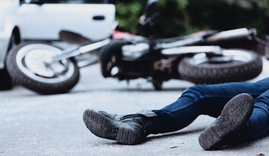 Motorcycle Injuries — Motorist On The Ground After The Accident in Visalia, CA Motorcycle Injuries — Motorist On The Ground After The Accident in Visalia, CA