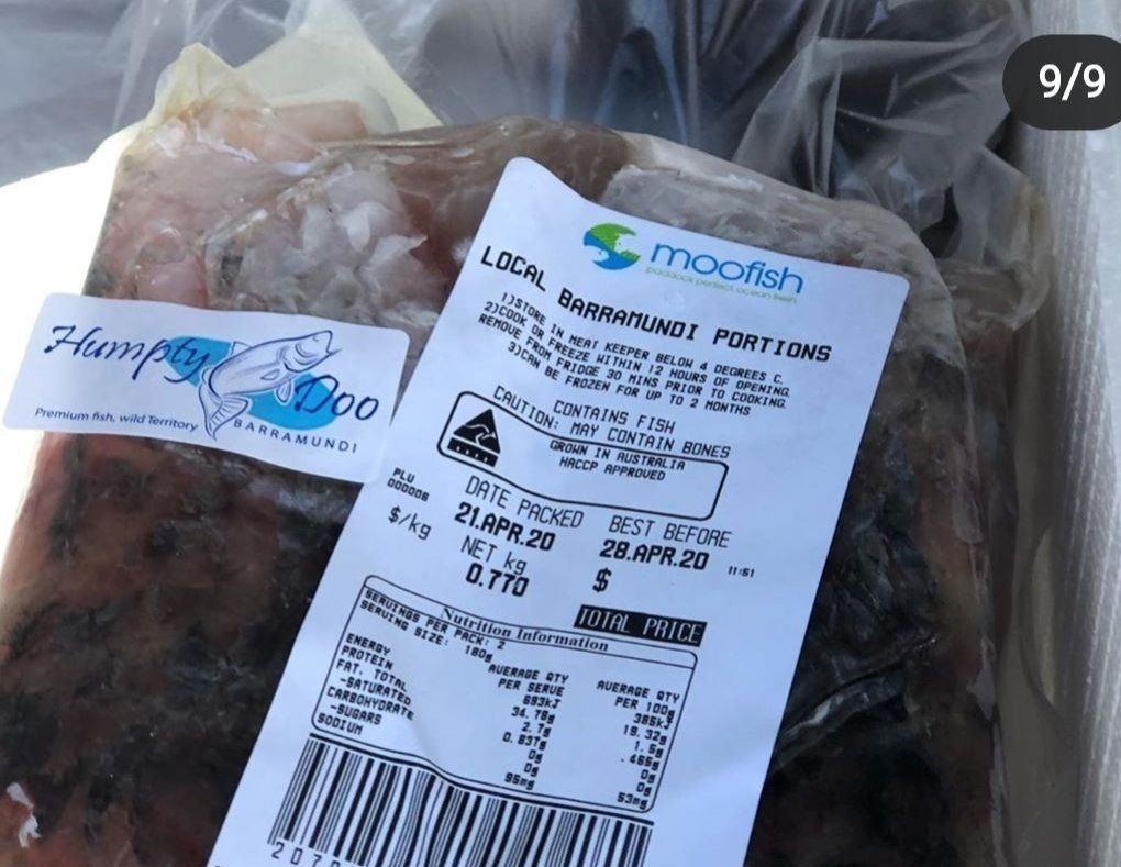 A plastic bag of frozen Humpty Doo barramundi fish portions with a label showing product details and a barcode.