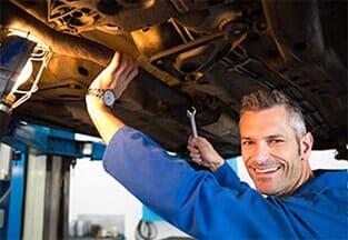 A man demonstrating car repair near Hermantown, MN