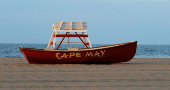 A red cape may boat sits on the beach