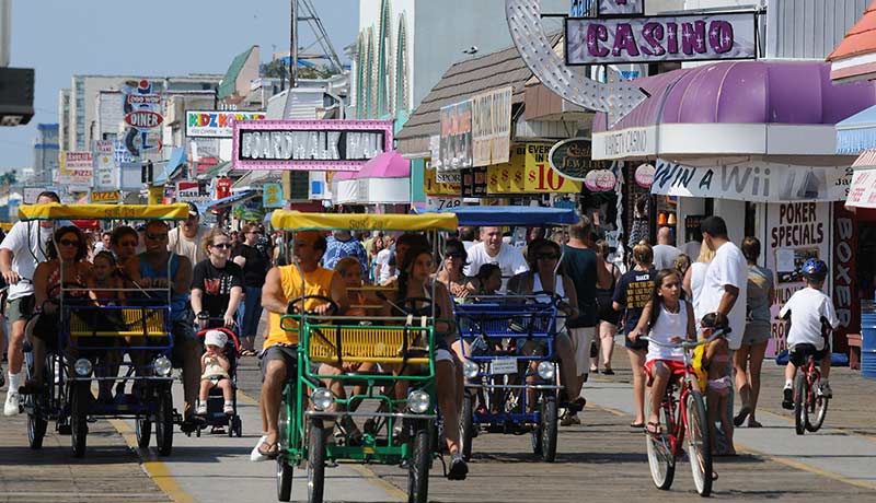 A group of people are riding bicycles down a street in front of a sign that says casino