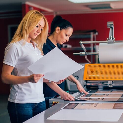 Two Women Working In A Printing Shop